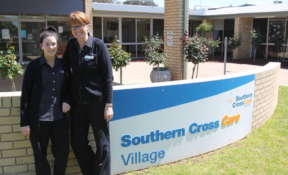 Maddison Byrne and Rita Smith work at the Southern Cross Care Village in Cootamundra. 