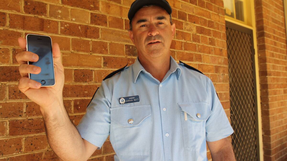 Sergeant Damian Nott says Cootamundra LAC recently destroyed seven mobile phones as part of an underage sexting investigation. Picture: Harrison Vesey