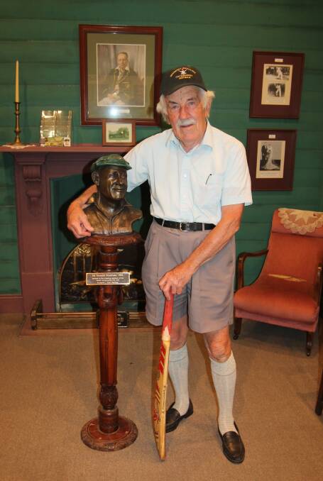 John Speechley poses with the popular bust and bat at the Bradman's Birthplace museum. Picture: Jennette Lees