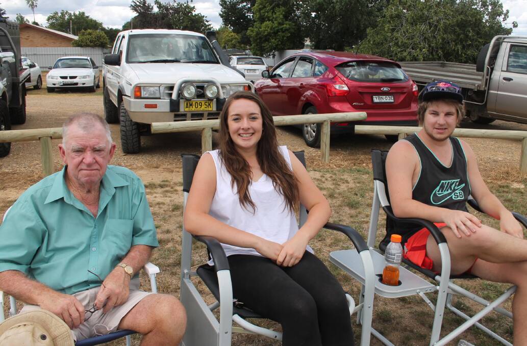 Supporters Ivan White, Tenelle Allan and Matt Wilson watch the reserve grade match prior to first grade. 