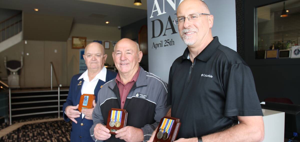 RECLAIMING WAR MEDALS: Stephen Brooks (right) reclaiming his ancestors' war medals from the Cootamundra RSL Sub Branch.