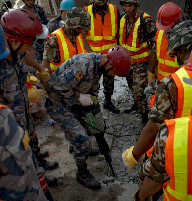 LOCAL CONNECTION: Members of the Nepalese Army work in the rubble of second earthquake in Nepal. The Red Cross Shop is thanking residents for their generosity.