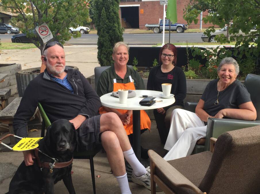 COFFEE: Loyal customers of The Pickled Pantry Ross Fitzell, Harry the dog and Jenny McClintock with employees Di Bray and Ash Holder.