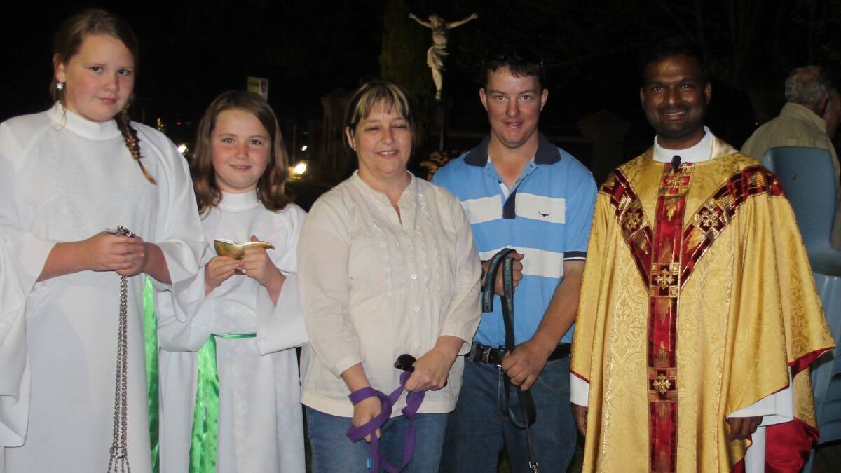 BLESSINGS: Altar servers Lauren and Cassie Mays, Leah and Joshua Sutherland together with their pet dogs Sasha and Bo, and Father Joshie. Picture: Contributed​