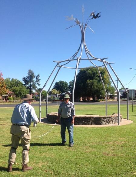 Cootamundra Rotarians Hugh Hamilton and Ray Luff measure out for the garden which will be built around the Peace Pavilion.