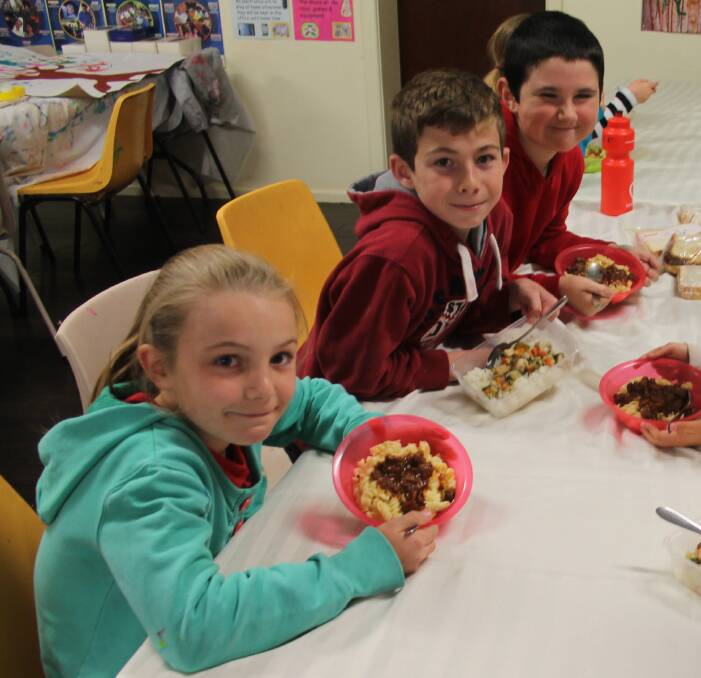 YUM: Sampling Skippy bolognaise and Thai green crocodile curry as part of Naidoc Week activities at Vacation Care are Aleisha Logue, Braith Sherry and Cooper Maclagan. Picture: Jennette Lees 