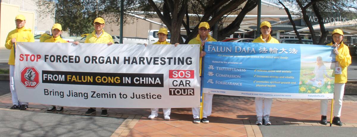 PROTEST: Falun Gong practitioners in Cootamundra on Tuesday protesting against alleged persecution in China of their fellow practitioners. Picture: Jennette Lees 