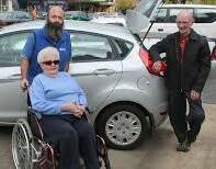 SOMETHING NEEDS TO BE DONE: Kevin and Kathleen Stewart with son Cr Craig Stewart show the narrow gap to get to the pavement proving problematic for wheelchair users last month. Since then Council has met and pledged to rectify parking spaces to a national standard. 
