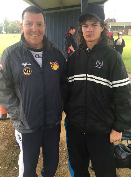 TRAGIC NEWS: A boy who loved his football, here Lui Polimeni of Jugiong, 15, meets with Bruce Barrett, father of legend of league Trent Barrett. 