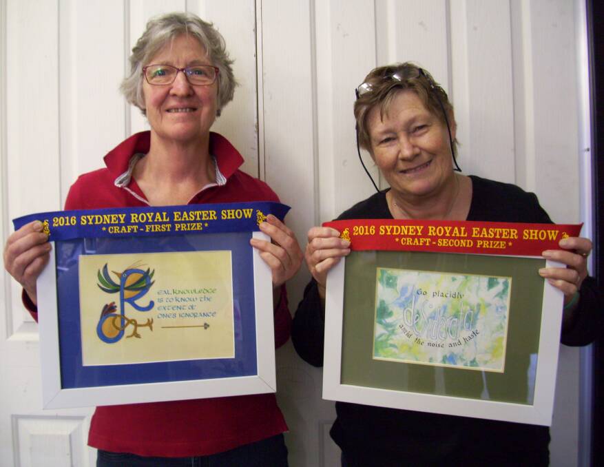 SCRIPT SAVVY: Lynette Angus and Annabelle Sullivan with the calligraphy artworks which saw them take out first and second place, respectively, at the Sydney Royal Easter Show. Picture: Contributed 


