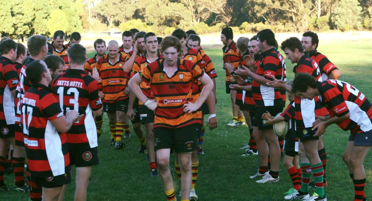 The Cootamundra Tricolours run out through a guard formed by hosts West Wyalong in Saturday's round of the Central West Rugby Graincorp Southern Division competition. Picture: West Wyalong Rugby Club