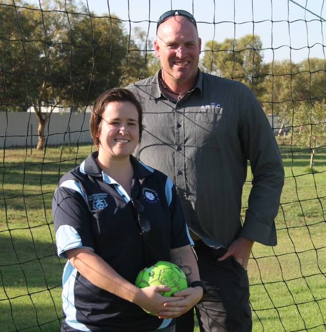 Mick Simons, coach, and Kat Gould, player, encourage players to sign up to the Women's Strikers soccer team this year. 
