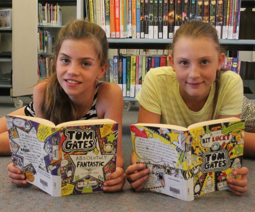 FOR THE LOVE OF READING: Wallendbeen's Chelsea Moore and Mikayla Starr at the Cootamundra Library this week. Picture: Jennette Lees 
