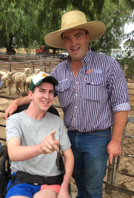HAVING FUN: Cootamundra's Angus Pennington with Holman Tolmie stock and station agent Corey Nicholson at Wednesday's sale. Picture: Contributed 