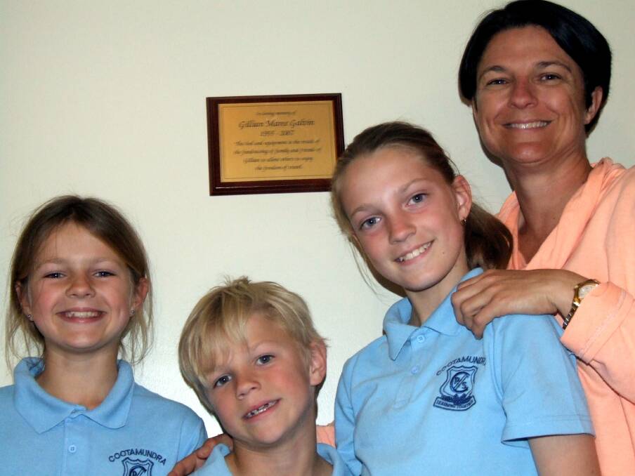 IN LOVING MEMORY: Andy, Reid, Ella and Tisha McTavish with the plaque honouring Tisha's mother Gillian Galvin in the Heritage Motel. Picture: Contributed