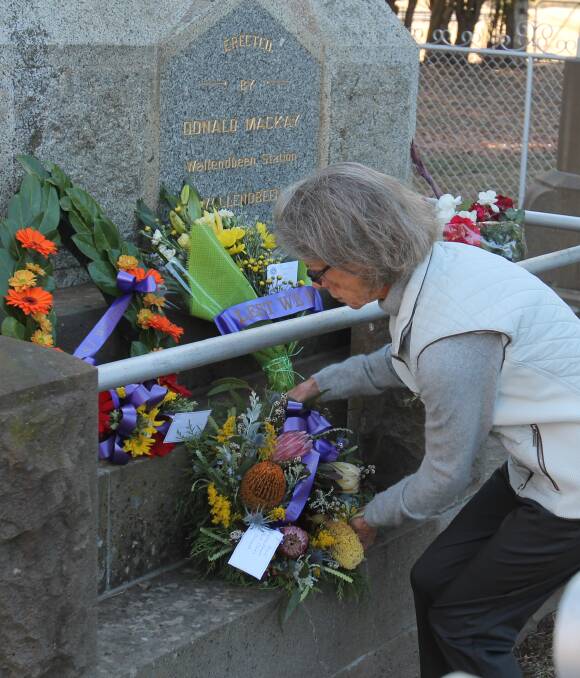 WITH RESPECT: Michele Baldy lays a wreath in Wallendbeen on behalf of Red Cross, donated by Janet Thorburn, who has laid a wreath for in excess of 60 years, however was unable to attend Monday's service. Picture: Christine Harrison