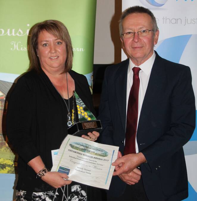 PROUD MOMENT: Australian Unity's Wendy Nasser is presented the Individual Dedication to Customer Service Award by the Ex-Services Club's Greg Bruce. Picture: Jennette Lees 