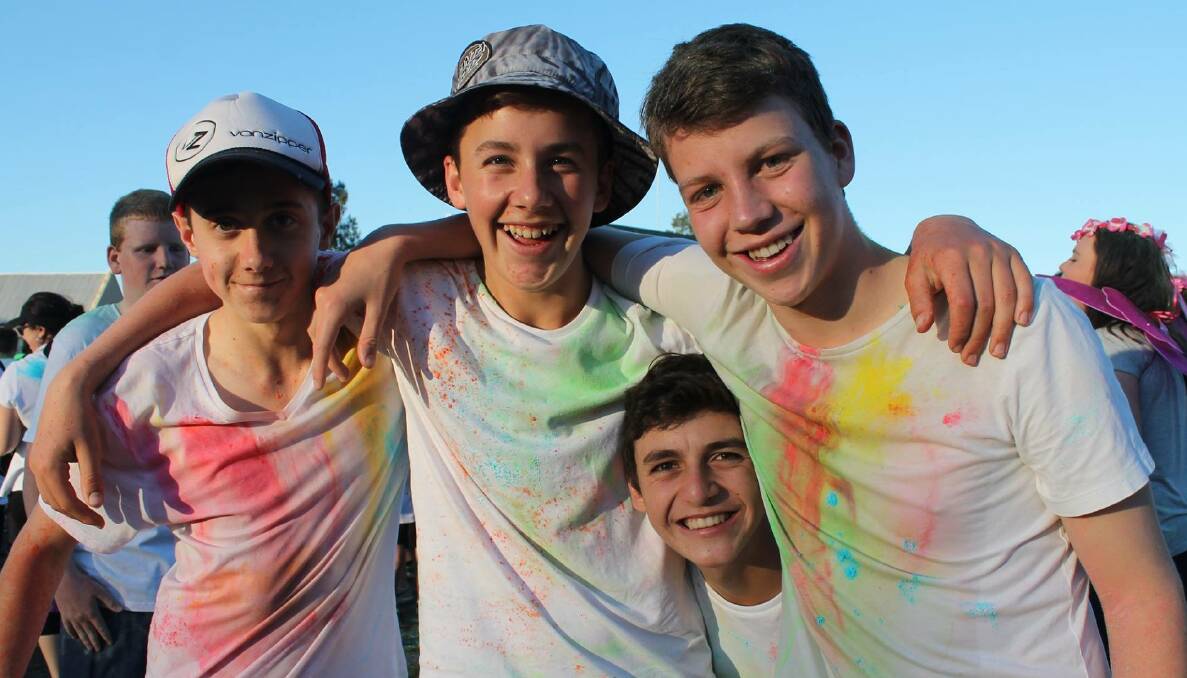 FUN: Jack Crick, Tom Drew and Jack Nasser with Lachie Deep peeking through have a
great time at last year's colour run. Picture: Contributed