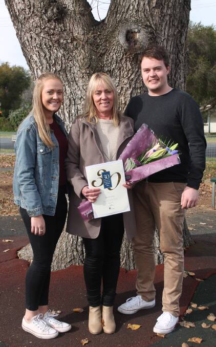 PROUD CAREER: Sharron Large, with her children Mikayla and Tom Large, who together with husband Phil surprised her at the assembly where she was presented a 30-year certificate. Picture: Jennette Lees 