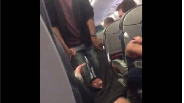 A fellow passenger's video showed the man being dragged through the aisle. Photo: Jayse Anspach