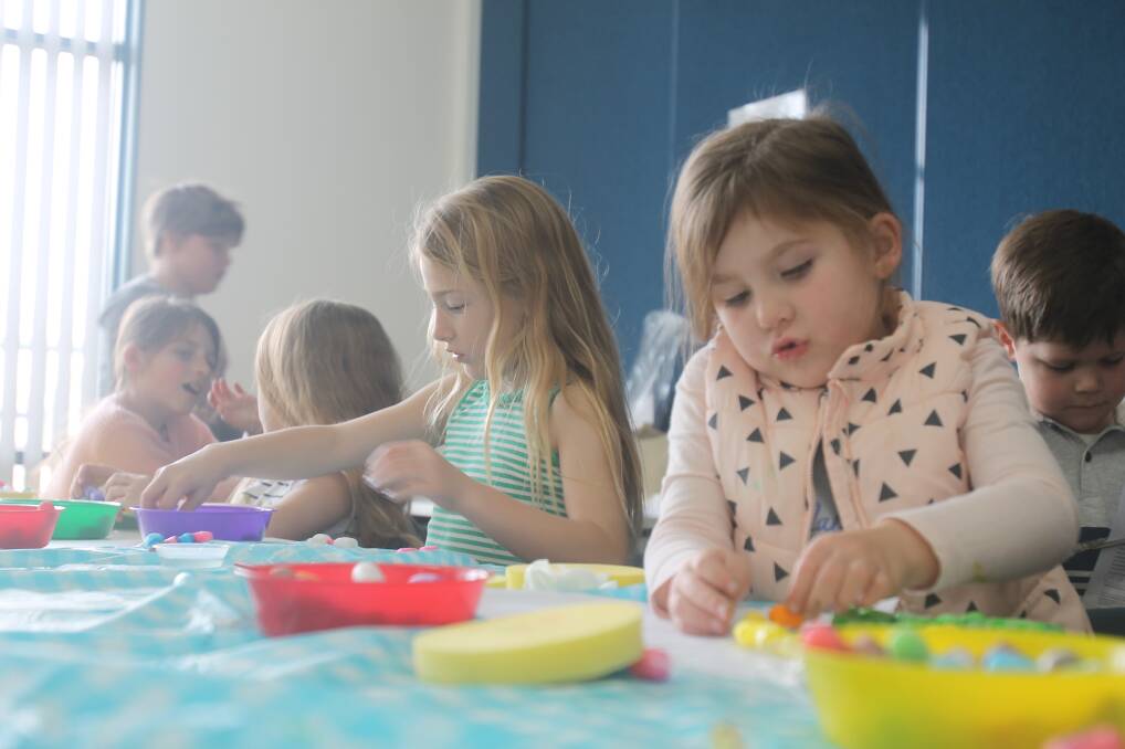 COLOURFUL CHARACTERS: Sarah Elmes and Ava Church were in serious crafting mode at the Cootamundra Library. Picture: Lachlan Grey