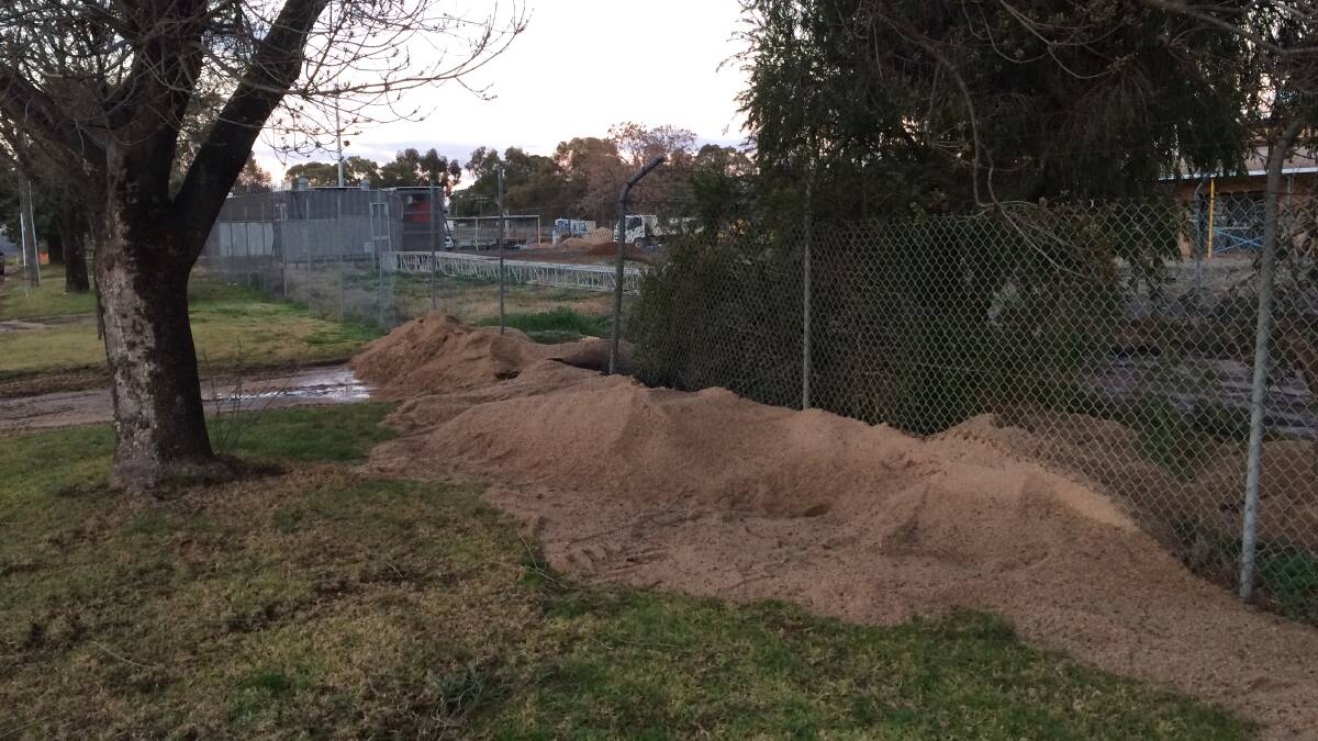 PILED UP: Sand was used to soak up the leak and prevent further contamination. Picture: Lachlan Grey
