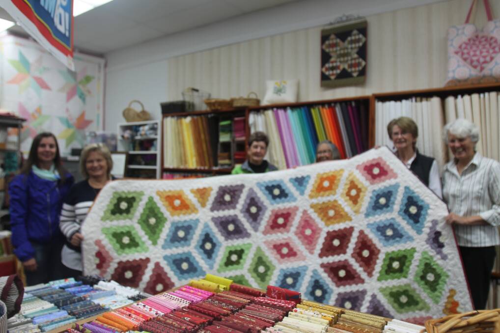 QUILTED: The staff at Patchwork on Parker teamed up with Can Assist for a marvellous raffle on Friday afternoon. Picture: Lachlan Grey. 