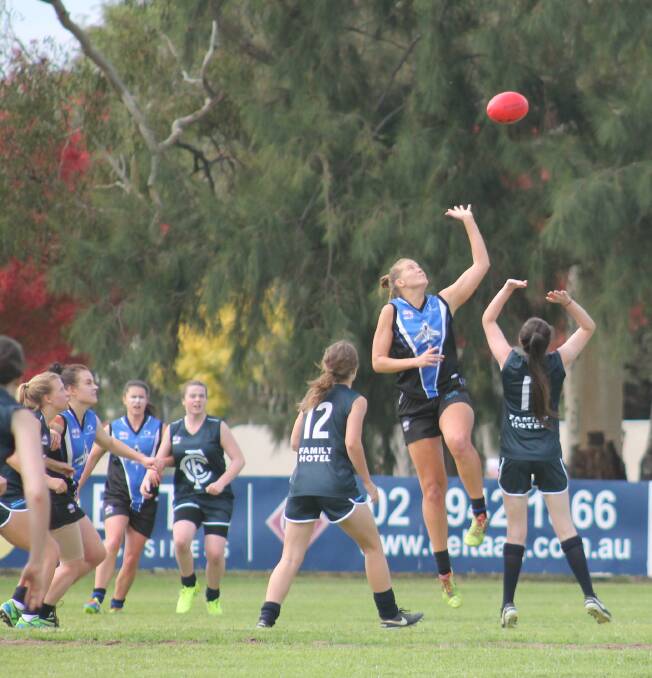 IN THE AIR: Cootamundra Blues and Gungahlin Jets compete for possession during Saturday's game. It was the first women's AFL competition game in the town.