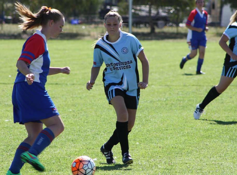 FOCUS: Strikers' Tanaelle Ecclestone shapes up to the Lions attack in a previous fixture. All three sides are eyeing off wins this weekend against Young and Henwood Park. Picture: Cootamundra Herald