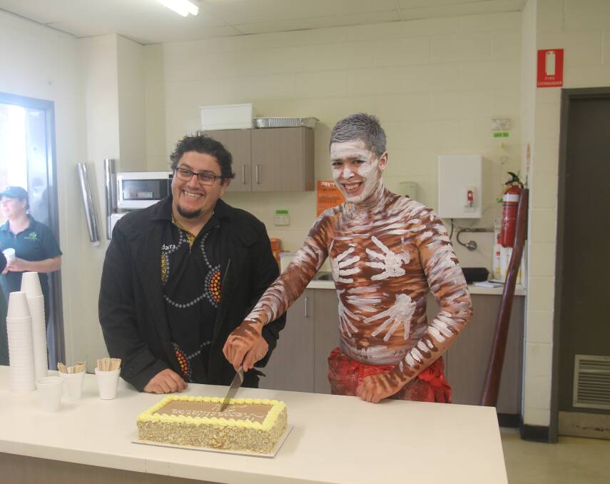 WEEK OF CELEBRATION: Wiradjuri man Peter Beath and Yuin man Kobi Russell cut the cake after a smoking ceremony in Cootamundra this morning. Picture: Lachlan Grey. 