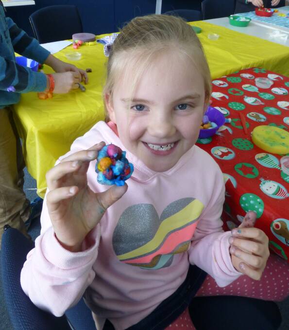 MINI MASTERPIECE: Mia Hines shows off her packing bean sculpture at the Cootamundra Library. Picture: Penny Howse 