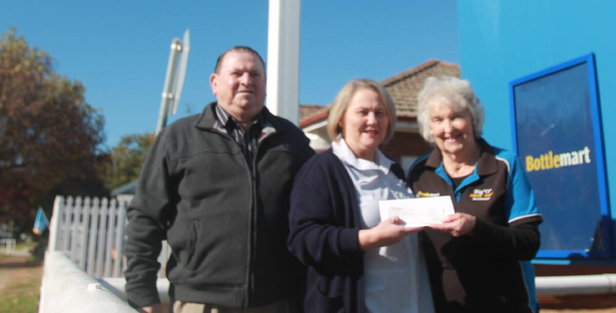 YEARS OF SUPPORT: Keith and Lola Daley (left and right) present Cootamundra Hospital nurse unit manager Sue McGlynn with the cheque. Picture: Lachlan Grey. 