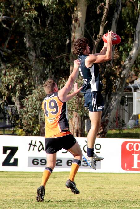 BIG WIN: Blake Basham (left) flies high for the Blues against Molonglo on Saturday. The Blues ran out out comprehensive winners by 37-22-244 to 1-1-7. Picture: Kelly Manwaring. 