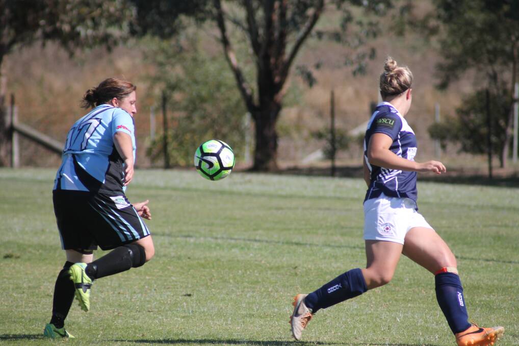 COMETH THE HOUR: Alana Simons (left) put in a vintage performance in her 200th game, netting the matchwinning goal in the 80th minute to see the Strikers home against the Young Lions. Picture: Lachlan Grey