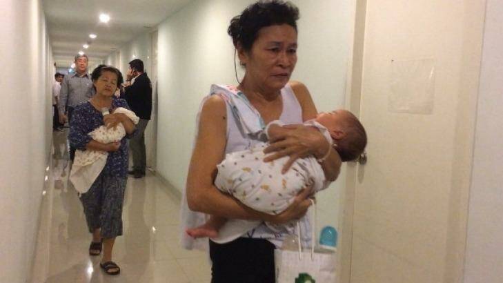 Officials conduct a raid on a surrogacy agency in Thailand in 2014. Photo: Thai Rath TV