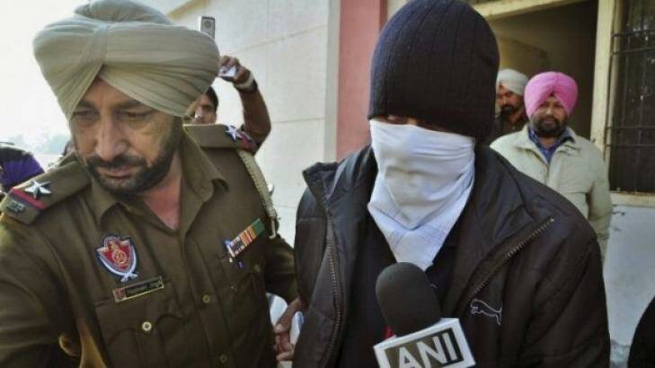 Indian national Puneet Puneet is escorted by police at a district court in India's northern Punjab state in 2013.