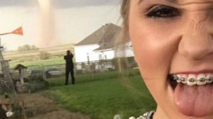 All smiles for the tornado: Ali Marintzer in a selfie, with date Charlie Bator in the background. Photo: Heidi Marintzer