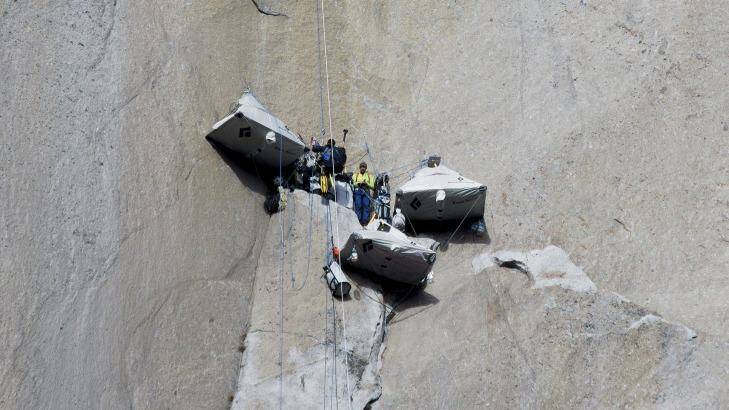 Tommy Caldwell (centre) stands with a photographer at a base camp before continuing to climb. Photo: AP/Tom Evans