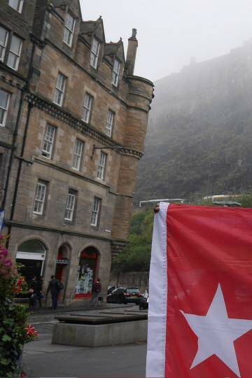 Benny Wenda flies the West Papuan flag in the shadow of Edinburgh Castle. Photo: Nick Miller