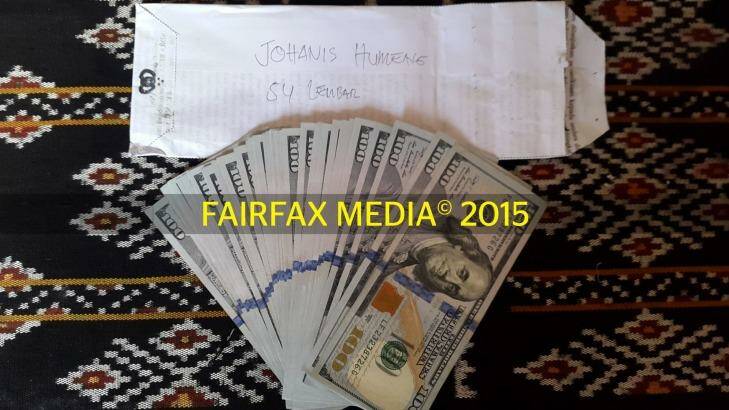 Three of six: Money used to pay people traffickers in Indonesia, and the envelope that carried it. Photo: Fairfax Media