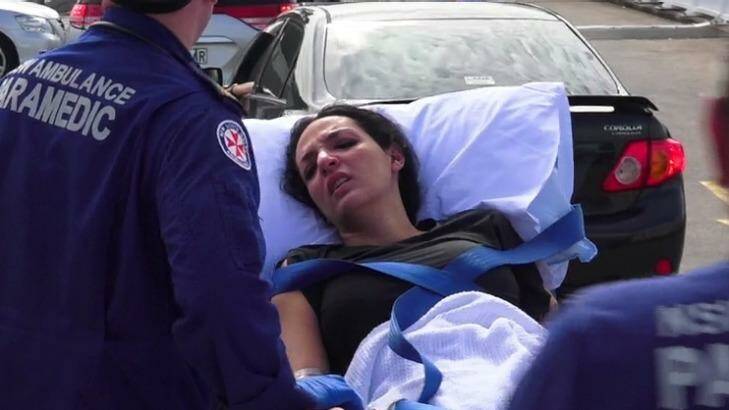 Innocent bystander: a woman receives treatment after the Bankstown shooting. Photo: Top Notch Video 