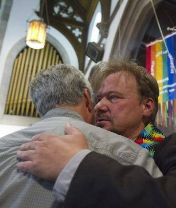 Reverend Schaefer hugs a supporter after his reinstatement in June. Photo: New York Times