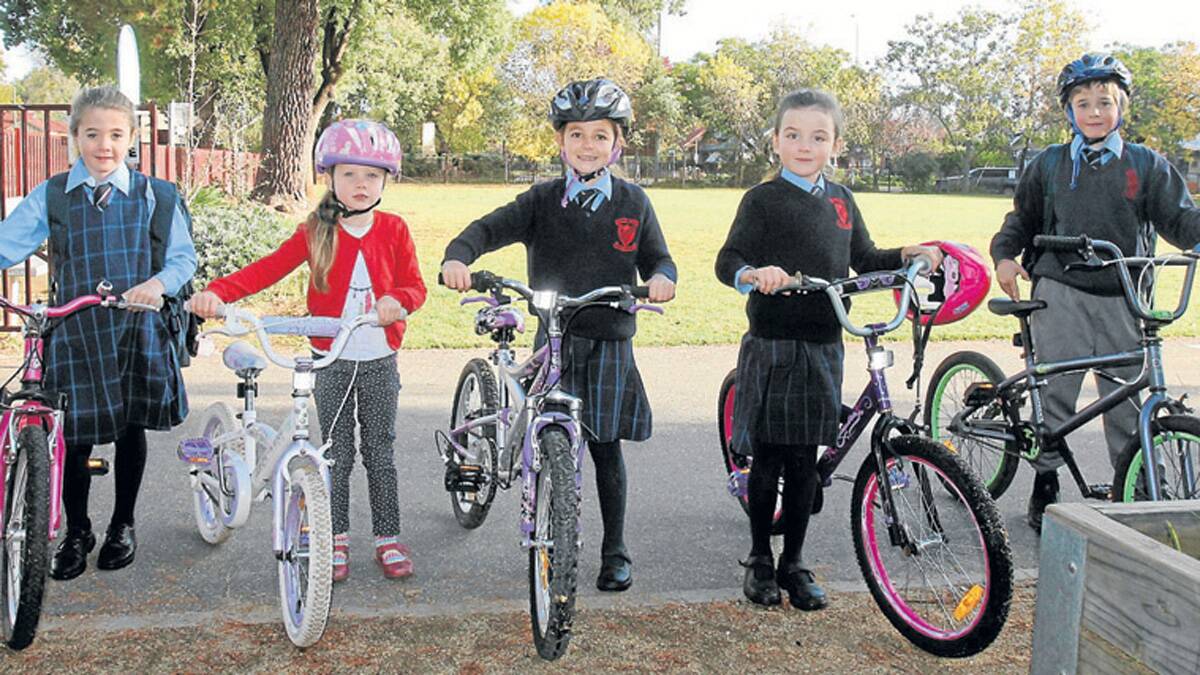 READY TO RIDE: pictured (from left) are Matilda Blackney, Talia Franklin, Lilly Deep, Eleanor Franklin and Jake Blackney who all ride their bikes to school. Children are being encouraged to ride to walk to school this Friday as part of National Walk Safely to School Day which is this Friday.    