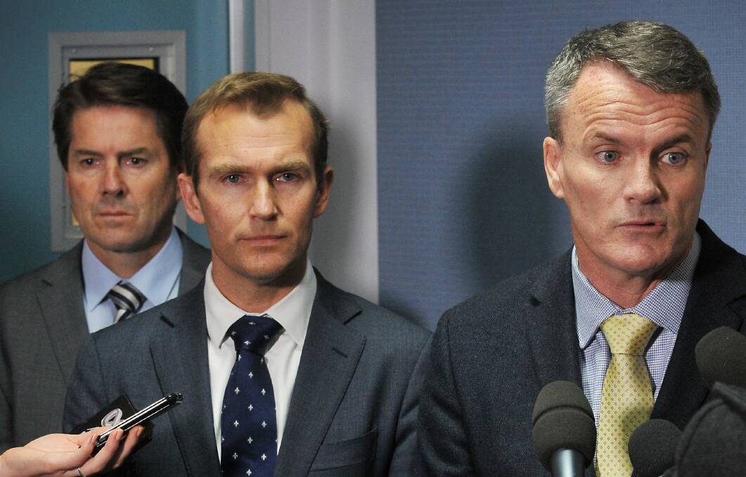 THEY KNEW: Environment Minister Rob Stokes, pictured centre with department chief Terry Bailey, right, and local MP Kevin Anderson, left, said they were aware of the issues in the Croppa Creek area which has now seen all operations on the ground suspended after Tuesday’s alleged murder. Photo: Gareth Gardner 310714GGA06