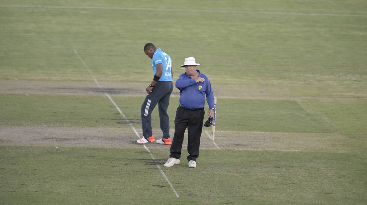 INVITATIONAL: Since moving to Canberra in 2012, former Cootamundra umpire Chris Cassin has continued his journey with Cricket Australia. He is pictured here standing as an umpire in the Prime Minister’s XI this year, confirming four runs off a no ball from English bowler Chris Jordan.