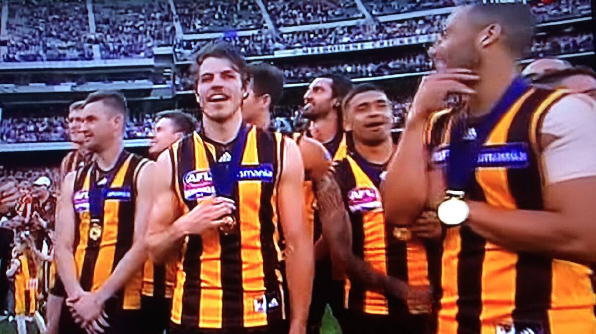 WHAT A MOMENT: Isaac Smith on the hallowed turf of the Melbourne Cricket Ground with his 2014 Premiership medal - a dream come true for the talented Aussie footballer from Coota. 