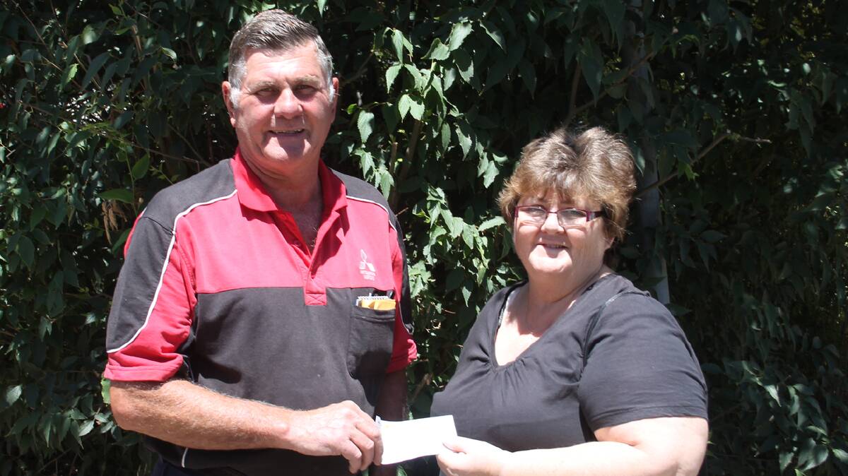 WITH THANKS: Cootamundra Lions Club president Paul Basham hands over a cheque for $6000 to the Cootamundra Nursing Home Sprinkler Appeal’s Cathy Manwaring. 