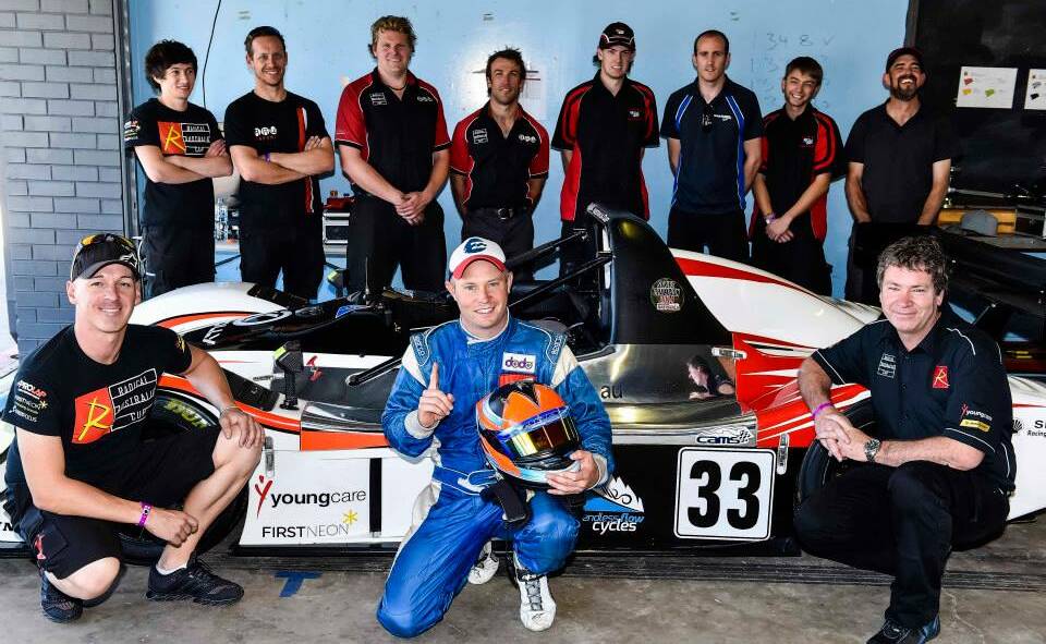   NATIONAL CHAMPION: Tim Berryman (centre) and the ‘works’ team celebrating the 2014 Radical Australia Cup series win at Sydney Motorsport Park in early November. Photo contributed.