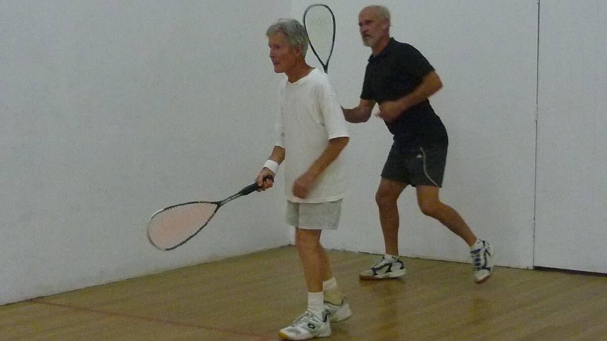 GETTING WARMED UP: John Finkle and Graeme Johnson do drills at the Cootamundra squash courts recently.