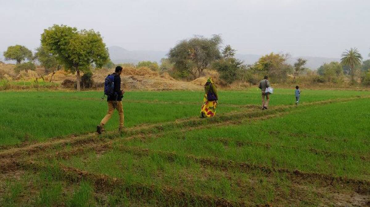  SCENIC ROUTE: Polio Vaccination Campaign 2014 volunteers walk across fields to reach children even in the most remote parts of India. 
Photo: Fiona Braybrooks